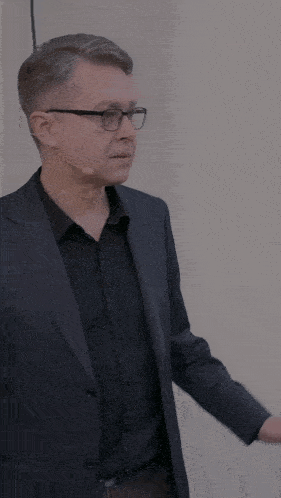 a man in a suit has a microphone around his ear
