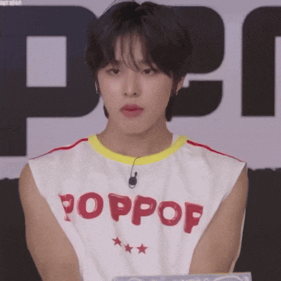a young man wearing a white tank top that says poppop on it