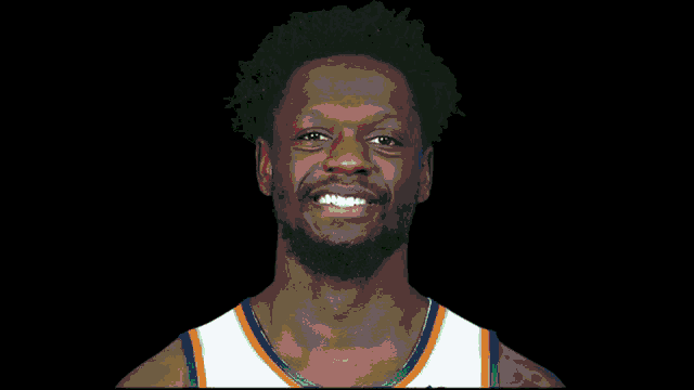 a basketball player is smiling with a green check mark over his face