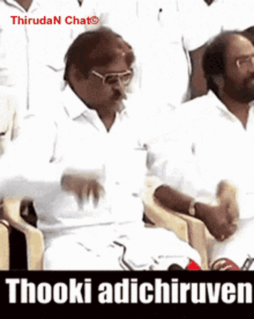 a man in a white shirt is sitting in a chair with the words thooki adichiruven written on the bottom
