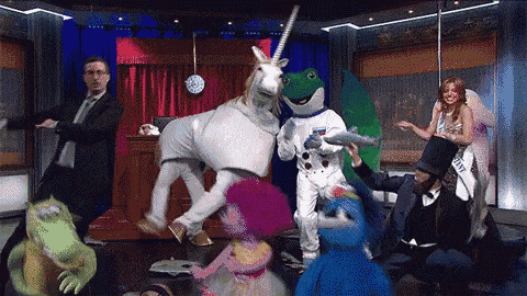 a group of people dressed in costumes including a frog and unicorn