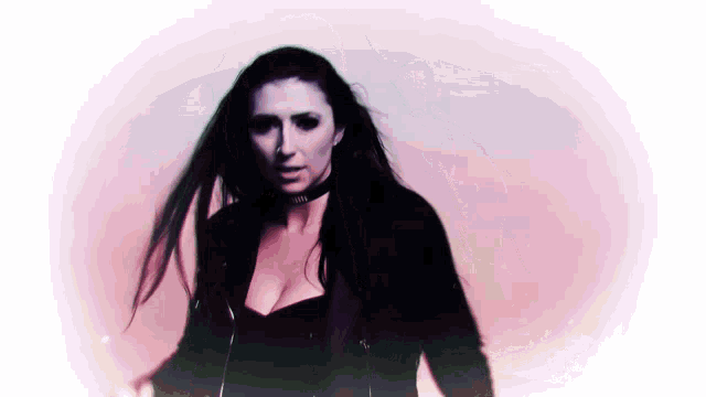 a woman wearing a choker and a black jacket stands in front of a pink background