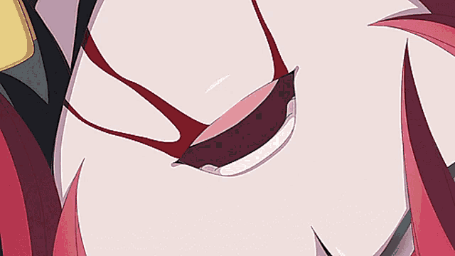 a close up of a woman 's mouth with white teeth and red hair