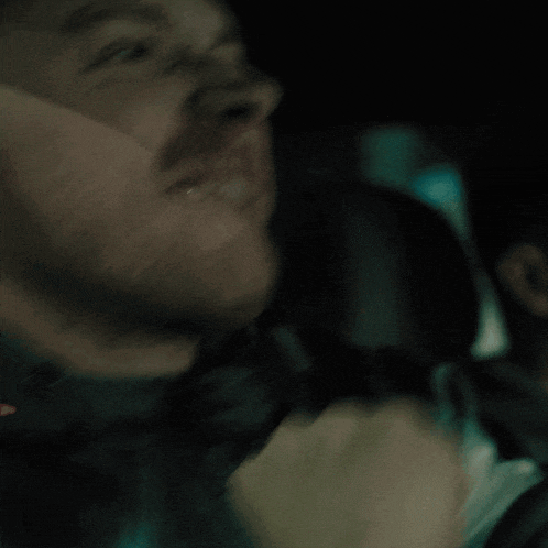 a close up of a man 's face with a blurred background