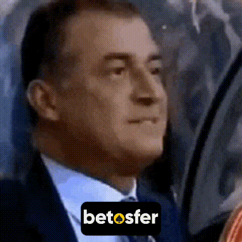 a man in a suit and tie is looking out a window with a betosfer sticker on it .