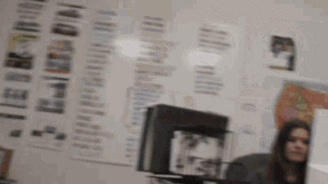 a blurred image of a woman sitting in front of a computer in front of a wall that says ted talk day