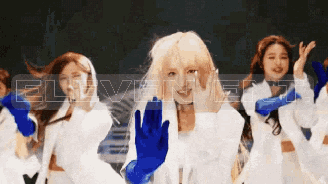 a group of girls are dancing with the word elevenent in the background