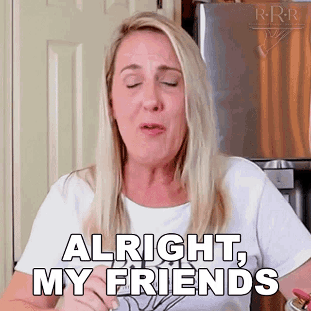 a woman says alright my friends in front of a stainless steel refrigerator