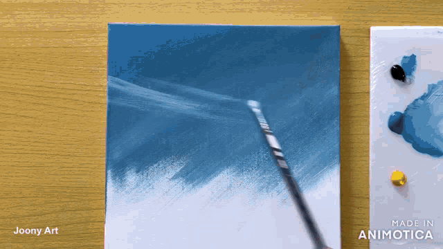 a painting is being painted on a canvas by joony art