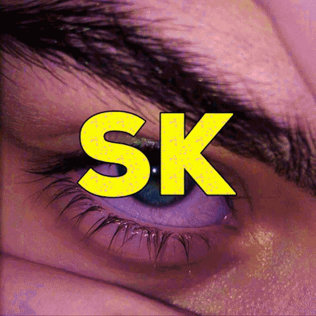 a close up of a person 's eye with the word sk written on it
