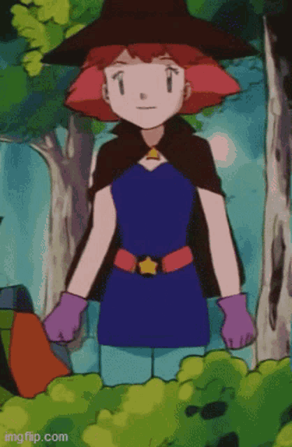 a girl in a witch costume is standing in a forest