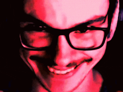 a man with glasses and a mustache is smiling