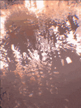 a close up of a rocky surface with a few spots of light on it