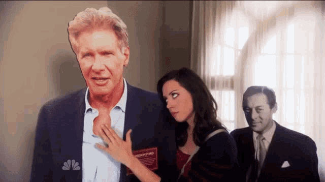 a man with a name tag that says harrison ford stands next to a woman