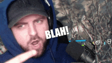 a man wearing headphones and a ny hat says the word blah