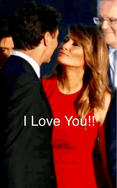 a man in a suit kisses a woman in a red dress with the words " i love you " written on the bottom