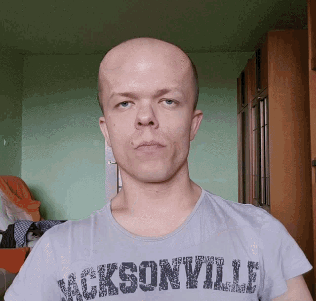 a bald man wears a jacksonville shirt