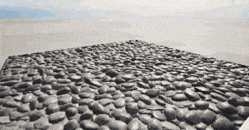 a pile of rocks is sitting on the ground in the desert