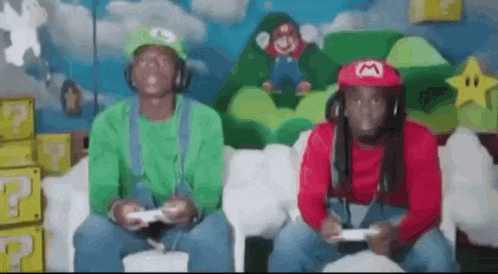 two men dressed as mario and luigi are playing a video game on a couch .