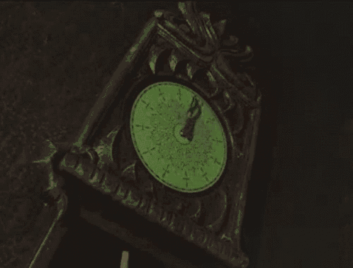 a clock with a green face shows that it is almost eleven