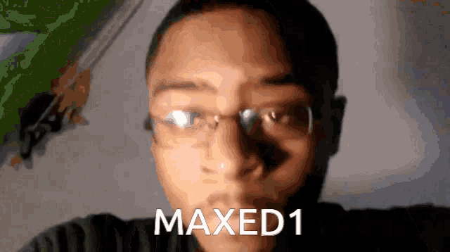 a close up of a man 's face with the words maxed1 written above him