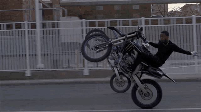 a man is doing a trick on a dirt bike with a monster energy drink on the back