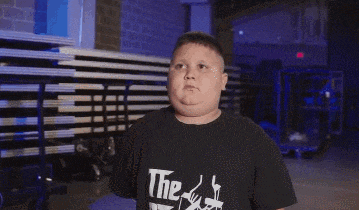 a boy wearing a black shirt that says " the " on it