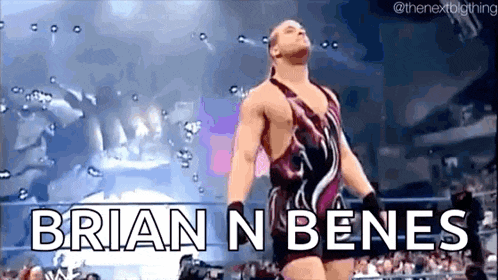 a man in a wrestling costume is standing in a ring with the words brian n benes written on the screen .