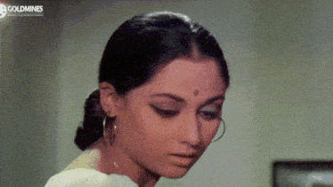 a close up of a woman 's face with goldmines written on the bottom