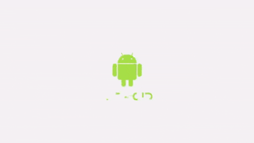 a green object is floating in the air with a white background behind it
