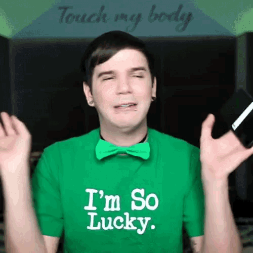 a young man wearing a green shirt that says i 'm so lucky