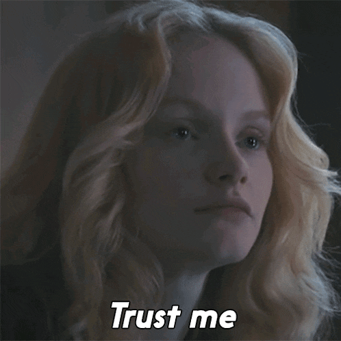 a woman with blonde hair says " trust me " in a dark room