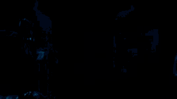 a person is walking up a set of stairs in the dark .