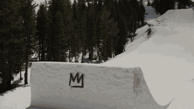 a snowy ramp with a red bull logo on the side