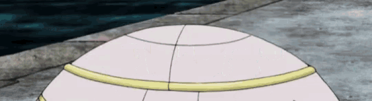 a white ball with a yellow stripe on it is sitting on a sidewalk next to a body of water .