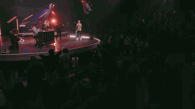 a man singing into a microphone while playing piano