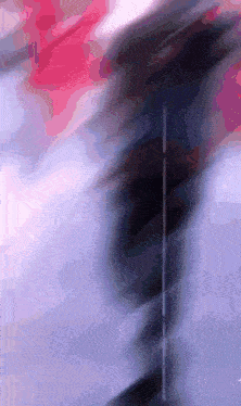 a blurry picture of a person 's face with the letter t on the bottom