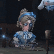 a girl in a blue dress is sitting at a table with a tray and a stuffed animal in the background .
