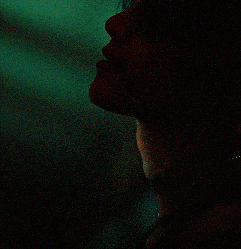 a close up of a woman 's face with a tattoo on her neck that says shine