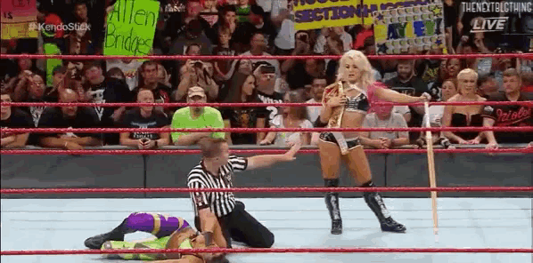a woman in a wrestling ring with a sign that says allen bridges on it