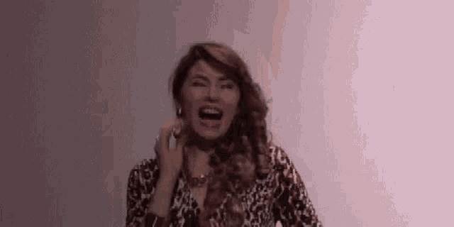 a woman is talking on a cell phone with her mouth open .
