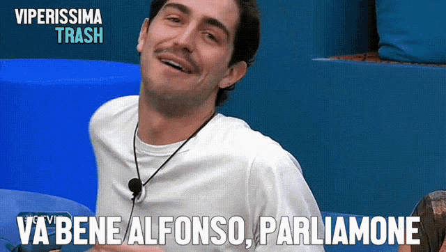 a man in a white shirt with a microphone around his neck says va bene alfonso parliamone