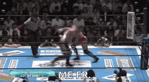 two men are wrestling in a wrestling ring with a referee watching .