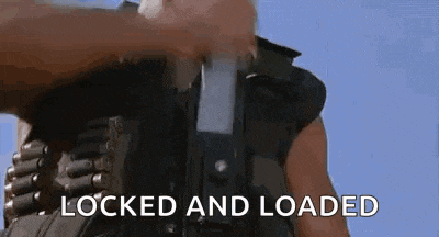 a man in a military uniform is holding a gun with the words `` locked and loaded '' written on it .