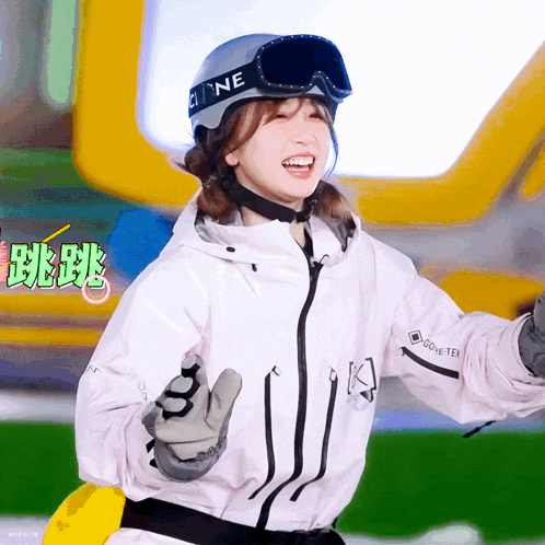 a woman wearing a helmet and goggles is wearing a jacket that says gore-tex
