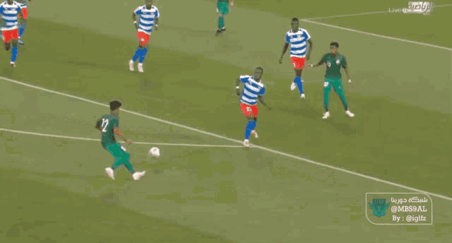 a soccer game is being played in front of a sign that says " saudi "