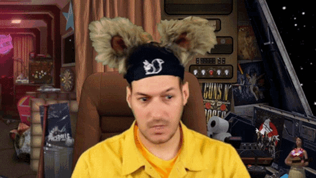 a man wearing a headband that says guns n ' roses