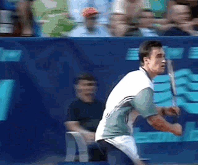 a tennis player is swinging a racket at a ball