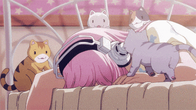 a girl with pink hair and headphones is laying on a bed with cats