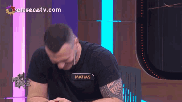 a man in a black shirt with the name matias on it